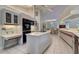 Open kitchen with island, built-in appliances, and adjacent dining area at 181 S Auburn Rd, Venice, FL 34292
