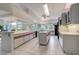 Spacious kitchen featuring white cabinetry with red accent stripes and a center island at 181 S Auburn Rd, Venice, FL 34292