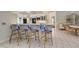Kitchen featuring a breakfast bar with seating, tile floors, and modern appliances at 181 S Auburn Rd, Venice, FL 34292