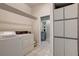 Laundry room with washer, dryer, and plenty of built in cabinet storage space at 181 S Auburn Rd, Venice, FL 34292