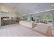 Open-concept living room with high ceilings, tile floors, and bar seating in background at 181 S Auburn Rd, Venice, FL 34292