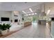 Open-concept living room features a fireplace, tile floors and backyard view at 181 S Auburn Rd, Venice, FL 34292