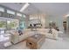 Bright living room with skylights, tile flooring, and open layout with views of the pool at 181 S Auburn Rd, Venice, FL 34292