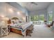 Primary bedroom with sliding glass door to a pool area and light, neutral decor at 181 S Auburn Rd, Venice, FL 34292