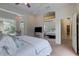 Bright main bedroom featuring a ceiling fan, bay window, and mirrored closet doors at 181 S Auburn Rd, Venice, FL 34292