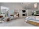 Spacious bedroom with lots of natural light, fireplace and access to additional living space at 181 S Auburn Rd, Venice, FL 34292