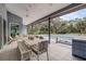 Covered patio featuring white table set with access and views of the pool and backyard at 181 S Auburn Rd, Venice, FL 34292