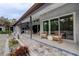 Spacious patio with outdoor seating and views of the well-maintained yard at 181 S Auburn Rd, Venice, FL 34292