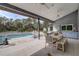 Relaxing covered patio with pool view and outdoor dining area in a serene setting at 181 S Auburn Rd, Venice, FL 34292