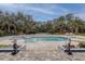 Outdoor pool featuring mature landscaping and access to a hot tub and lounge area at 181 S Auburn Rd, Venice, FL 34292