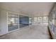 Covered outdoor porch featuring a large sliding glass doors, providing ample natural light and ventilation at 181 S Auburn Rd, Venice, FL 34292