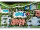 Birds eye view of clubhouse amenities including swimming pool, bocce ball court, and ample parking at 19240 Isadora St, Venice, FL 34293