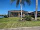 Backyard with a screened-in patio surrounded by well-maintained landscaping at 19240 Isadora St, Venice, FL 34293