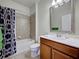 Bathroom with tiled shower/tub combination, a single sink, and a decorative mirror at 19240 Isadora St, Venice, FL 34293