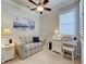 Cozy bedroom with striped loveseat, white desk, shuttered window, and beach-themed decor at 19240 Isadora St, Venice, FL 34293