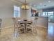 Charming dining room featuring a round table with four chairs and an elegant chandelier at 19240 Isadora St, Venice, FL 34293