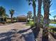 Charming home featuring a brick driveway, a two-car garage, and lush tropical landscaping at 19240 Isadora St, Venice, FL 34293