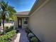 Charming home entrance with a brick path, glass-paneled door, and manicured landscaping at 19240 Isadora St, Venice, FL 34293