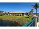 Scenic view of the home's exterior and lanai from a charming neighborhood bridge at 19240 Isadora St, Venice, FL 34293