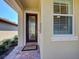 Elegant front door with decorative glass and brick entryway, enhancing the home's curb appeal at 19240 Isadora St, Venice, FL 34293