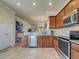 Modern kitchen with stainless steel appliances and an adjacent dining area at 19240 Isadora St, Venice, FL 34293