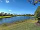 Community lake surrounded by houses and palm trees at 19240 Isadora St, Venice, FL 34293