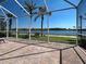 Screened lanai overlooking a tranquil lake view with lush landscaping at 19240 Isadora St, Venice, FL 34293