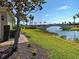 Beautiful landscaping featuring an arched bridge, tropical plants and shrubs, and a well manicured lawn at 19240 Isadora St, Venice, FL 34293