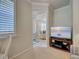 View from the office into the living room featuring a beach-themed tv, coastal decor, and a striped rug at 19240 Isadora St, Venice, FL 34293