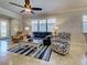 Bright living room with comfortable seating, tile floors, and view into entryway at 19240 Isadora St, Venice, FL 34293