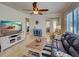 Open-concept living space with a television, comfortable seating, and neutral decor at 19240 Isadora St, Venice, FL 34293