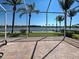 Tranquil screened patio with water views and lush palm trees provides an ideal outdoor space for relaxation and enjoyment at 19240 Isadora St, Venice, FL 34293
