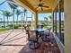 Screened-in patio featuring a ceiling fan, brick flooring, and a beautiful lake view at 19240 Isadora St, Venice, FL 34293