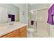 Bathroom featuring vanity, toilet, and glass-enclosed shower with a seat at 20246 Pezzana Dr, Venice, FL 34292