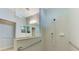 Well-lit bathroom with grab bars and neutral tile shower at 20246 Pezzana Dr, Venice, FL 34292