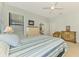 Cozy bedroom with dresser, chair, and a comfortable bed next to a window at 20246 Pezzana Dr, Venice, FL 34292