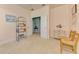 Spacious carpeted bedroom with double doors and sitting area at 20246 Pezzana Dr, Venice, FL 34292