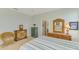 Relaxing bedroom with light green walls, wood furnishings, and an attached bathroom at 20246 Pezzana Dr, Venice, FL 34292