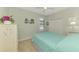 Bright bedroom with a full-size bed, closet and floral accents at 20246 Pezzana Dr, Venice, FL 34292