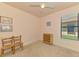 Small bedroom with a window providing natural light and neutral carpeting at 20246 Pezzana Dr, Venice, FL 34292