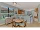 Bright dining area features a round table and chairs next to a sunlit window and built-in hutch at 20246 Pezzana Dr, Venice, FL 34292