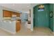 Open-concept kitchen and entryway with bright, airy ambiance and a charming chandelier at 20246 Pezzana Dr, Venice, FL 34292