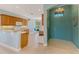 Bright entryway with tiled floors, leading to an open kitchen and a view of the dining area at 20246 Pezzana Dr, Venice, FL 34292