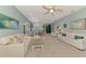 Spacious living room with white couches, dining area, and an open floor plan that is perfect for entertaining at 20246 Pezzana Dr, Venice, FL 34292