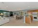 Bright, open living space with view to the kitchen and access to the backyard and lake views at 20246 Pezzana Dr, Venice, FL 34292