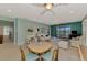 Open living room featuring an area with a round table and chairs, along with white furniture and water view at 20246 Pezzana Dr, Venice, FL 34292