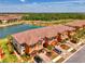 Stunning aerial view of new townhomes near a tranquil lake and mature trees at 20390 Lagente Cir, Venice, FL 34293