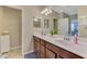Bathroom featuring double sinks, granite counters, ceramic tile and views to an adjacent bedroom at 20390 Lagente Cir, Venice, FL 34293