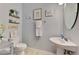 Powder bathroom with pedestal sink, decorative artwork and toilet at 20390 Lagente Cir, Venice, FL 34293