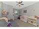 Bedroom features carpet floors, a ceiling fan, window and crib at 20390 Lagente Cir, Venice, FL 34293